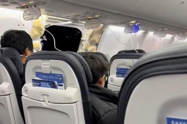 This image from video provided by Elizabeth Le shows passengers near the damage on an Alaska Airlines Boeing 737 Max 9, Flight 1282, which was forced to return to Portland Internatio<em></em>nal Airport on Friday.